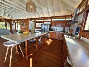 a kitchen with a large island in the middle at Makana 7 in Ponta Mamoli