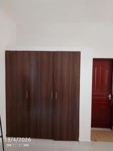 a pair of wooden cupboards in a room at Chemba's Paradise in Galu