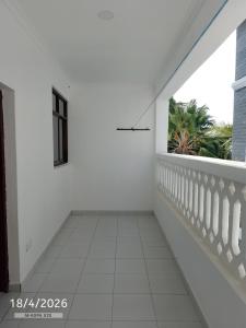 a white room with a balcony with a window at Chemba's Paradise in Galu