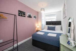 a small bedroom with a bed and a window at Earp House - Allerton Liverpool Stay - Sleeps 7 in Liverpool