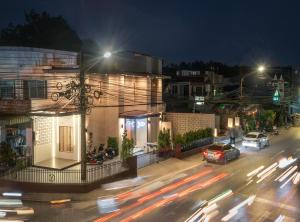 a city street at night with cars on the road at Yoo Pool Villa Ranong in Ban Lum Than