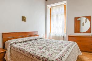 a bedroom with a bed and a dresser and a window at Casa Luana in Lucignano