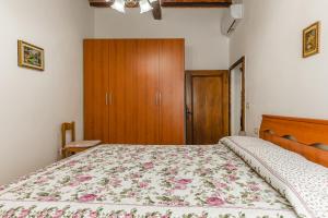 a bedroom with a bed and a wooden cabinet at Casa Luana in Lucignano