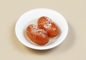 two donuts in a white bowl on a table at Hotel The Unify in Jāmb