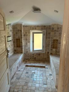 a tiled bathroom with a window and a tub at Kaya Amari in Fethiye +13 photos