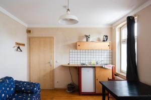 a living room with a table and a kitchen at Fabrik Gästehaus in Neustrelitz +20 photos