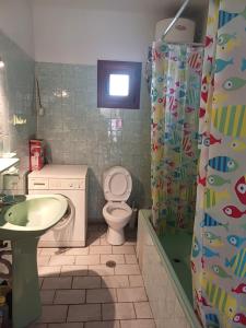 a bathroom with a toilet and a sink and a shower at LA.KI House in Kavála +52 photos