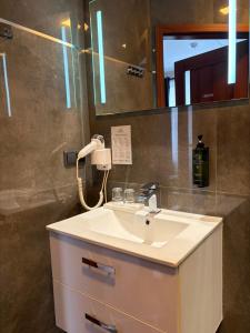 a bathroom with a sink and a mirror at Edel Wellness Sleep & Spa in Gniezno