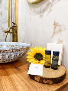 a counter with two bottles of essential oils and a bowl at Mirando Espanha in Melgaço