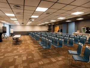 an empty room with chairs and a table and a podium at ibis Bordeaux Centre Meriadeck in Bordeaux