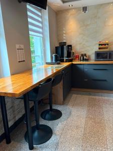 a kitchen with a wooden table and two chairs at Edel Wellness Sleep & Spa in Gniezno +26 photos