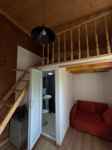 a room with a loft bed and a red couch at Jonson in Poti
