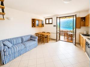 a living room with a couch and a table at Dolce Vita LakeView - By Turidea in Sale Marasino
