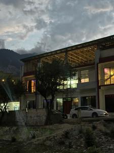 a building with a car parked in front of it at Comfort Inn in Kalām