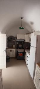 a kitchen with white appliances and a green light at Dar HJAIJA in Hammamet