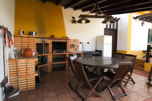a dining room with a table and some chairs at Quinta Moinho Meirinho in Crato