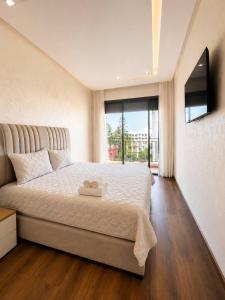 a bedroom with a large bed with a large window at Premium studio Casablanca in Maarif