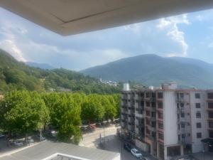 a view of a building with mountains in the background at Appartement la Liberté in Albertville