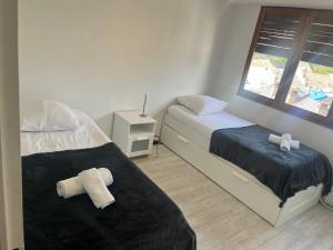 a bedroom with two beds and a window at Appartement la Liberté in Albertville