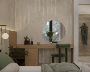 a living room with a circular mirror and a chair at Vinárstvo Jurovčík in Lošonec
