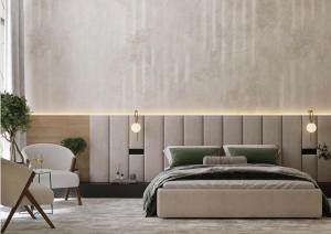 a bedroom with a large bed and a wall at Vinárstvo Jurovčík in Lošonec