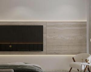 a bedroom with a tv on the wall at Vinárstvo Jurovčík in Lošonec