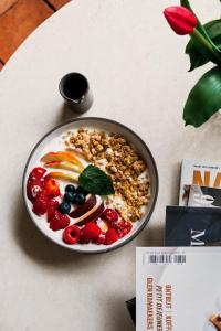 a bowl of cereal with fruit on a table at K-Kanne in Kanne