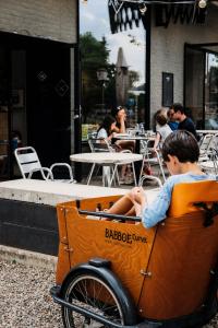a young boy sitting in an orange cart at K-Kanne in Kanne