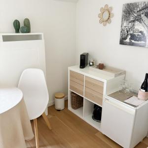 a white desk and a white chair in a room at De Watermolen in Ninove