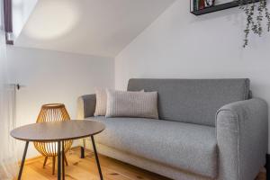 a living room with a couch and a table at Apartmán TICHO - Ostrůvek in Lesná +33 photos
