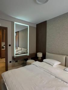 a bedroom with a bed and a large mirror at Nordic Nest Kolašin in Kolašin