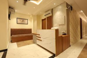 a bathroom with a sink and a bench in a room at Yu Hotel in Kānpur +30 photos