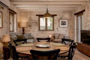 a living room with a table and chairs at Casa Falco in Vasilikos