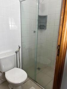 a bathroom with a toilet and a glass shower at Hotel Palace Huesca in Presidente Prudente +8 photos