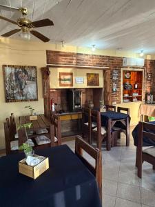 a dining room with tables and chairs and a ceiling fan at Hotel Village Termas de Dayman in Termas del Daymán
