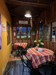 a restaurant with two tables and chairs in a room at Hotel Village Termas de Dayman in Termas del Daymán