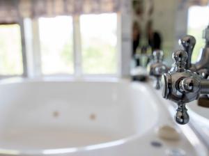 a bathroom sink with a faucet on top of it at Turistgården Töcksfors in Töcksfors +67 photos