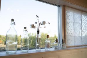 a row of bottles sitting on a window sill at Solhaven in Selfoss