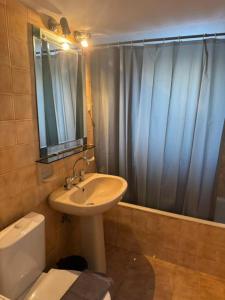 a bathroom with a sink and a toilet and a shower at Kalloni Village House in Kalloní