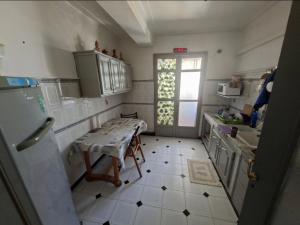 a small kitchen with a table and a window at Appart Hana in Bab Ezzouar