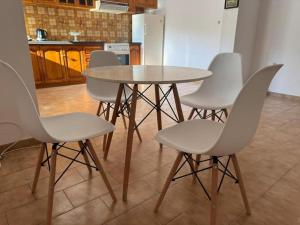 a table and four chairs in a kitchen at Kalloni Village House in Kalloní +14 photos