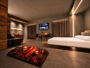 a bedroom with a bed and a fire place at Agarthi Suites in Piateda +14 photos