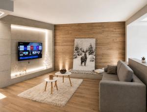 a living room with a couch and a tv at Agarthi Suites in Piateda