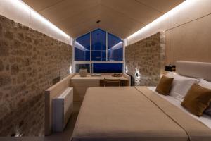 a bedroom with a bed and a sink and a window at Eks Mani Peninsula Retreat in Pirgos +21 photos