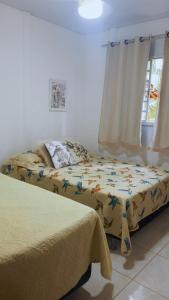 a bedroom with two beds and a window at Sítio recanto do Saltinho Santa teresa -ES in Santa Teresa +87 photos