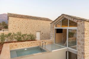 an external view of a house with a swimming pool at Eks Mani Peninsula Retreat in Pirgos