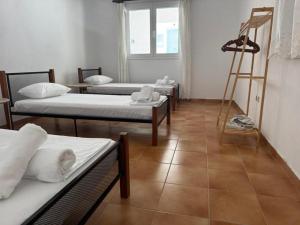 a room with four beds and a ladder at Kalloni Village House in Kalloní