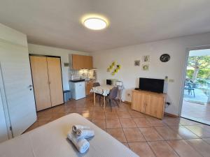 a large living room with a kitchen and a table at Apartment Burja with Olive Grove & Salt Pans View in Portorož