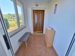 a room with a chair and a window and a door at Apartment Burja with Olive Grove & Salt Pans View in Portorož +22 photos