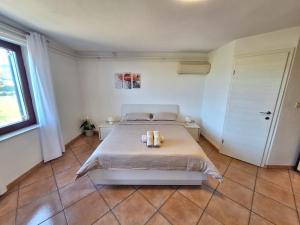 a bedroom with a bed with two candles on it at Apartment Burja with Olive Grove & Salt Pans View in Portorož